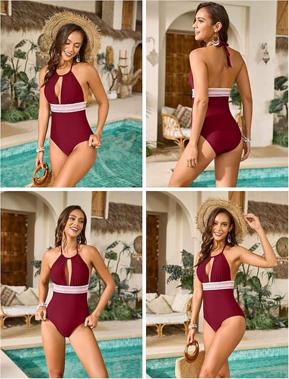 Woman in a maroon one-piece swimsuit with a white waistband stands and poses by a pool in an outdoor setting, holding a straw hat and a woven bag.