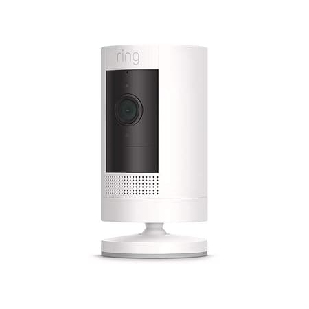 A white Ring indoor security camera with a black front panel and lens, mounted on a round base, shown against a plain background.