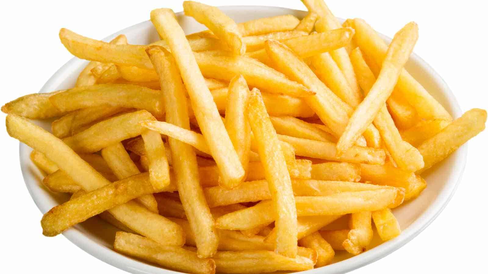 A white bowl filled with golden, crispy French fries on a white background.