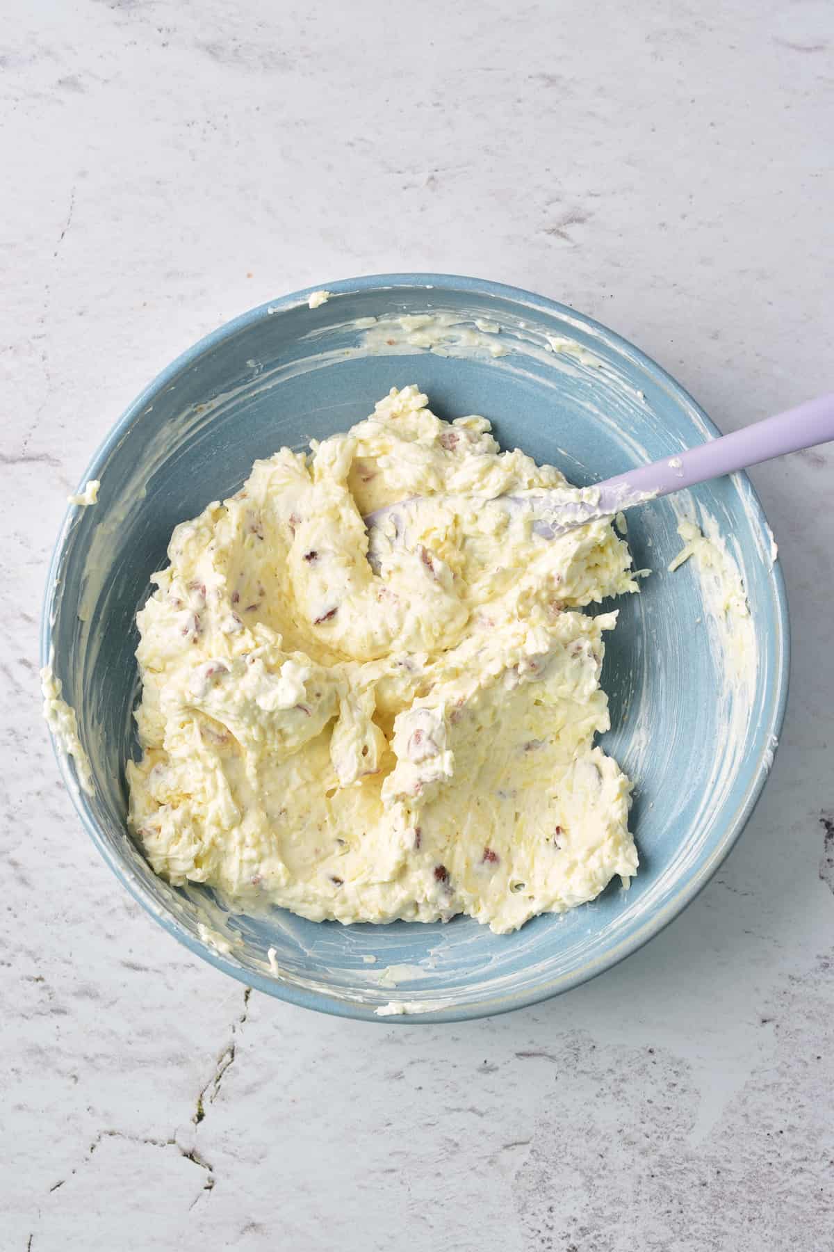 A bowl of cream with a spoon