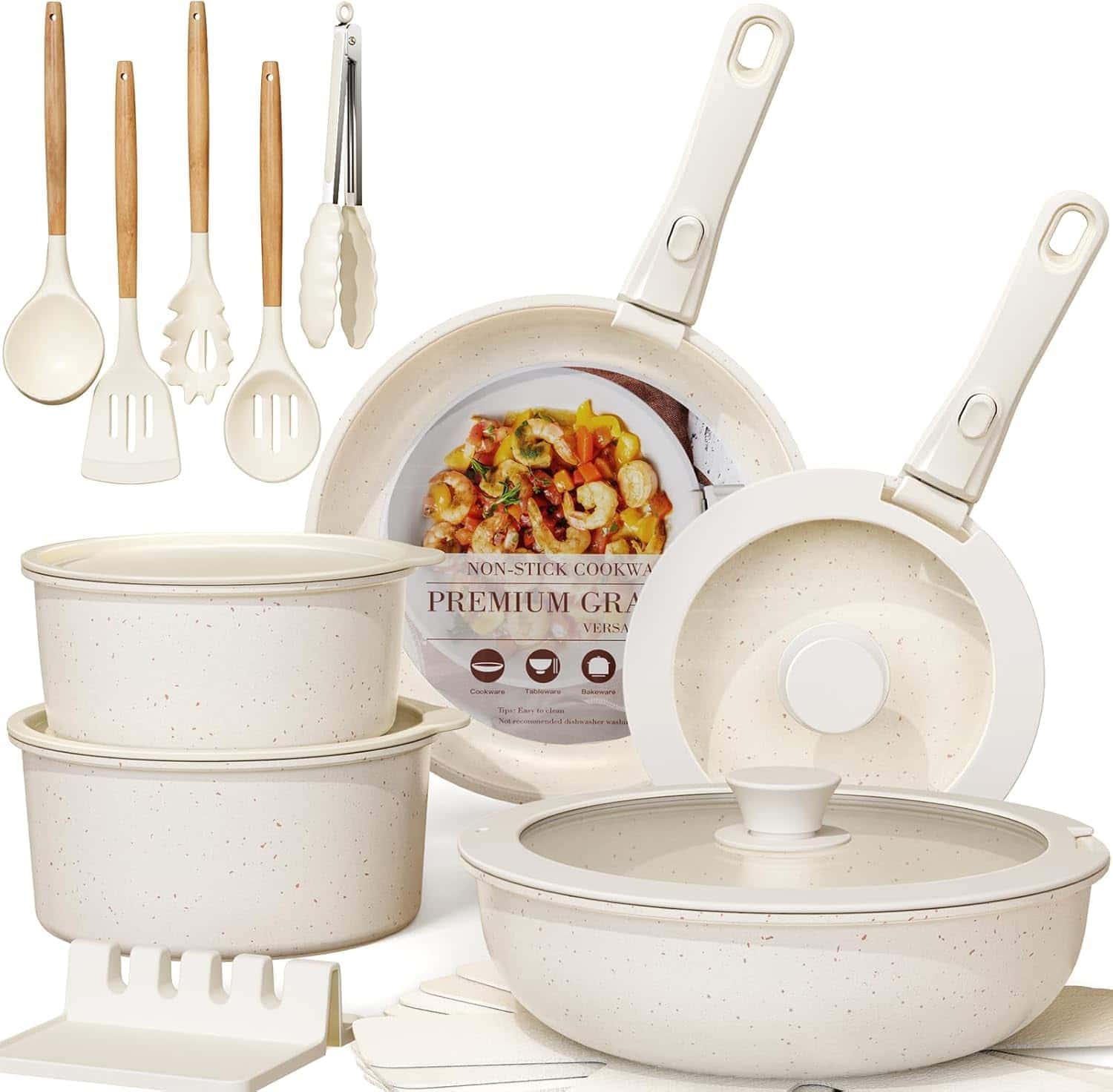 A cream-colored non-stick cookware set with pots, pans, lids, cooking utensils, kitchen tongs, and a rack, all displayed on a white background.