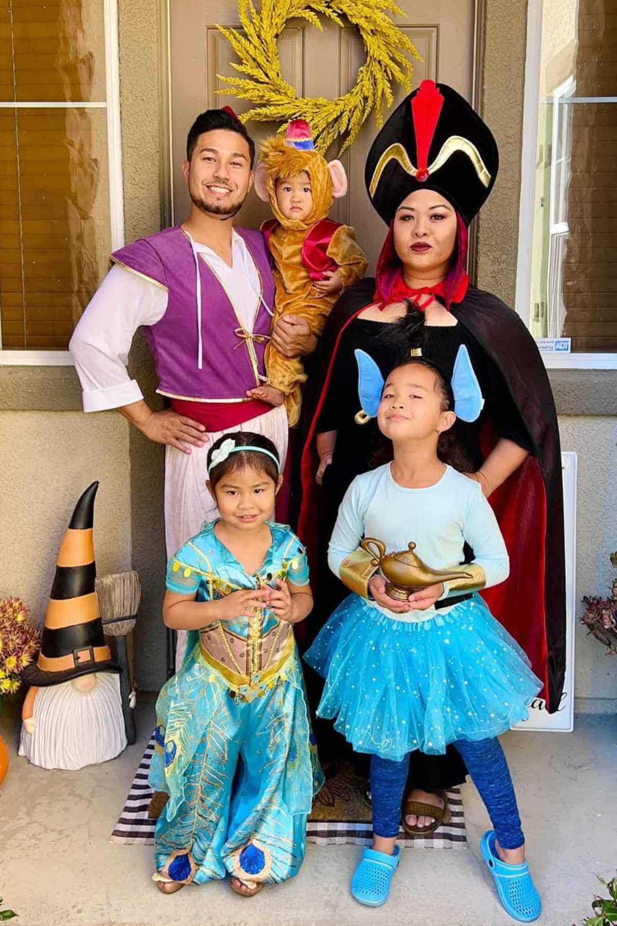 A family of five wearing costume characters inspired by Aladdin movie.