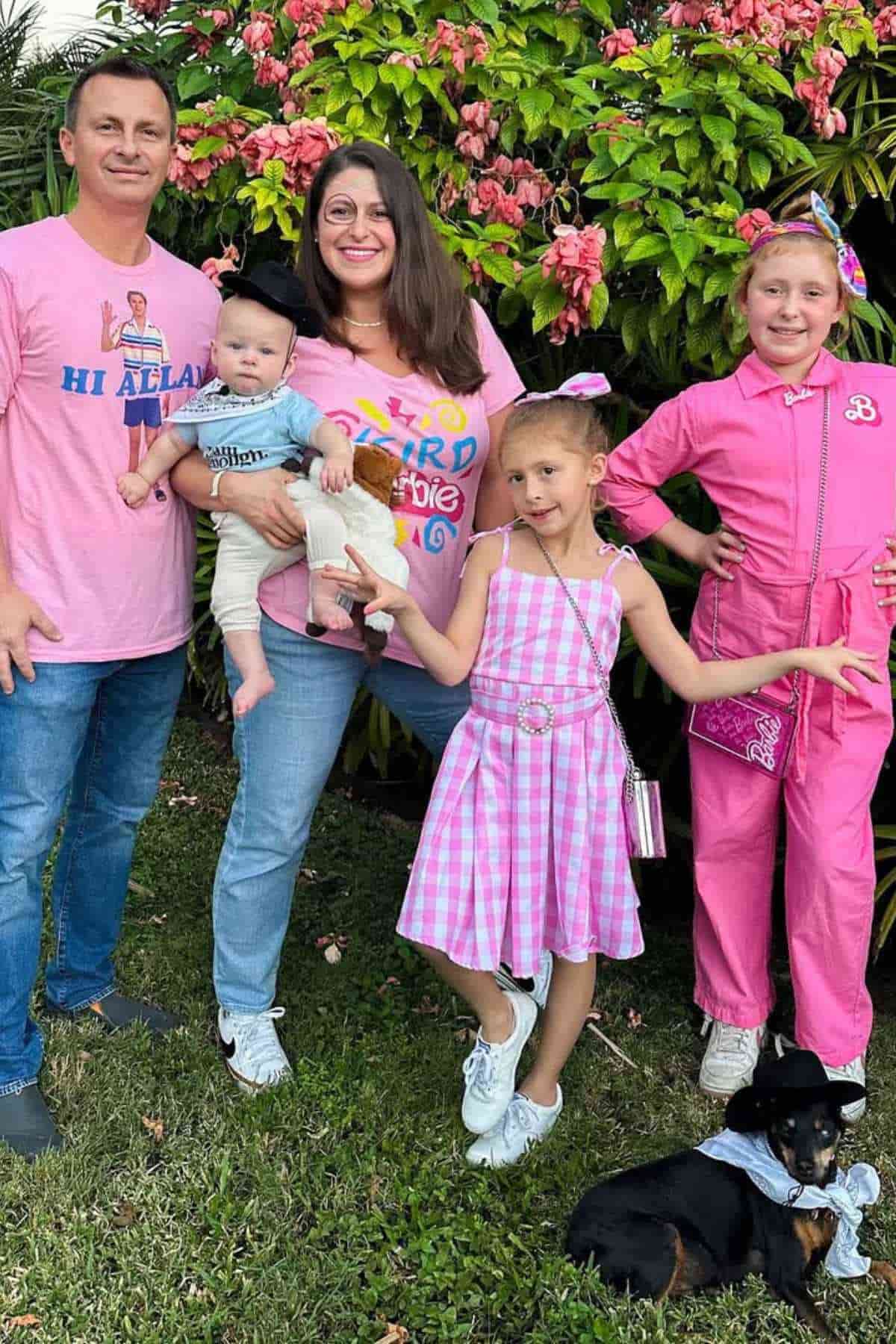 A family of five wearing wearing pink costumes inspired by Barbie.