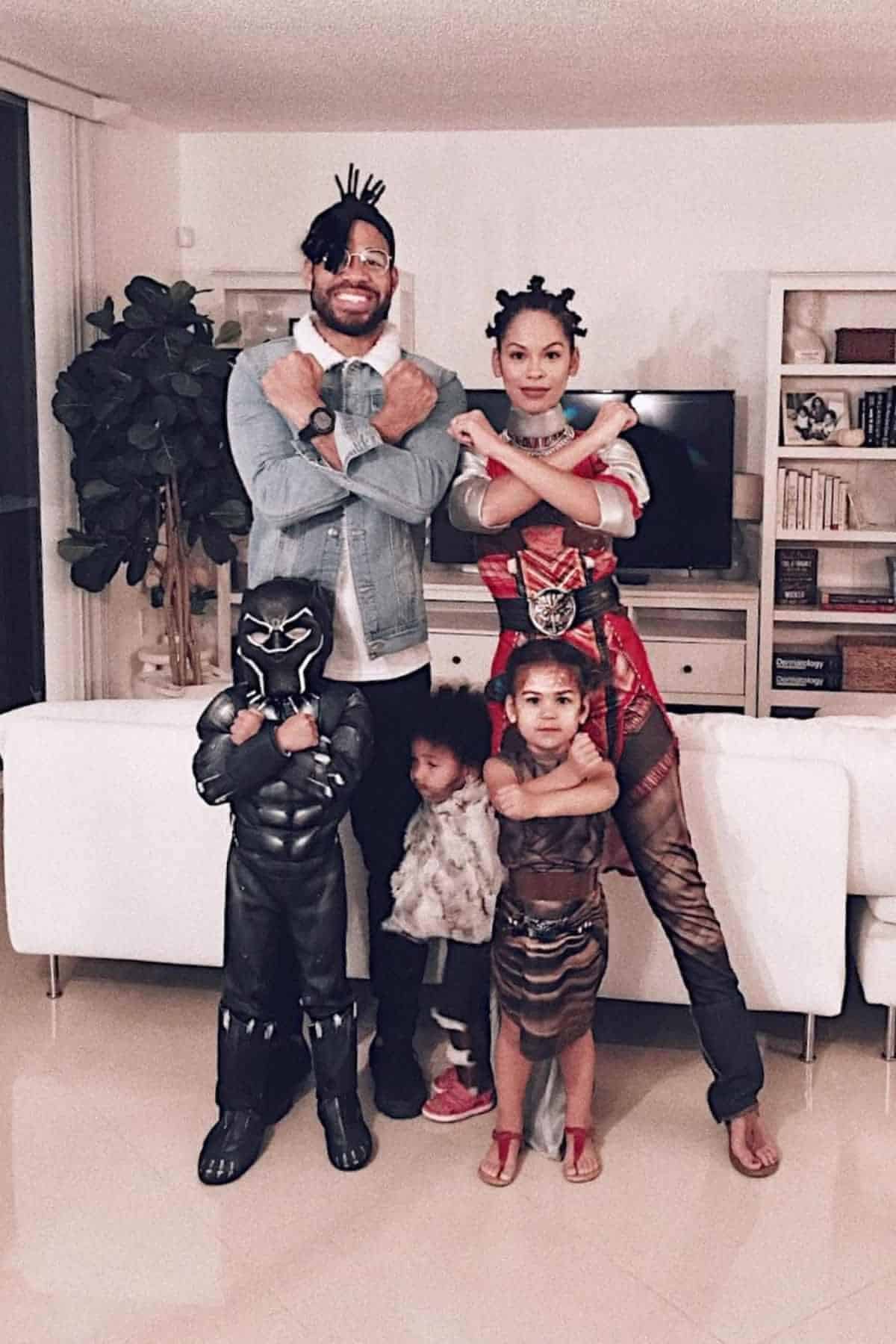 A family of five wearing costumes inspired by "Black Panther" characters.