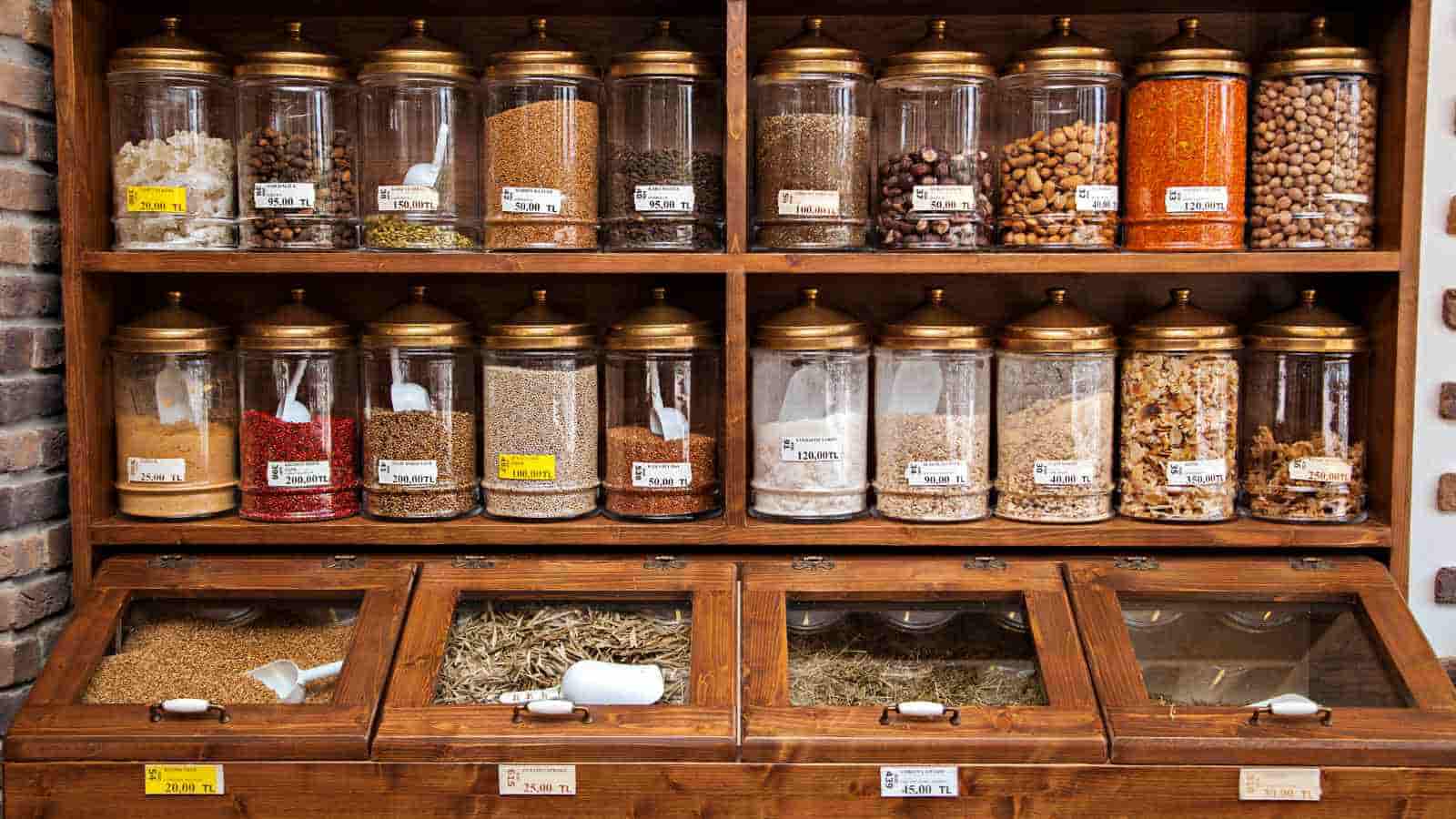 A rack full of spices in glass bottles.