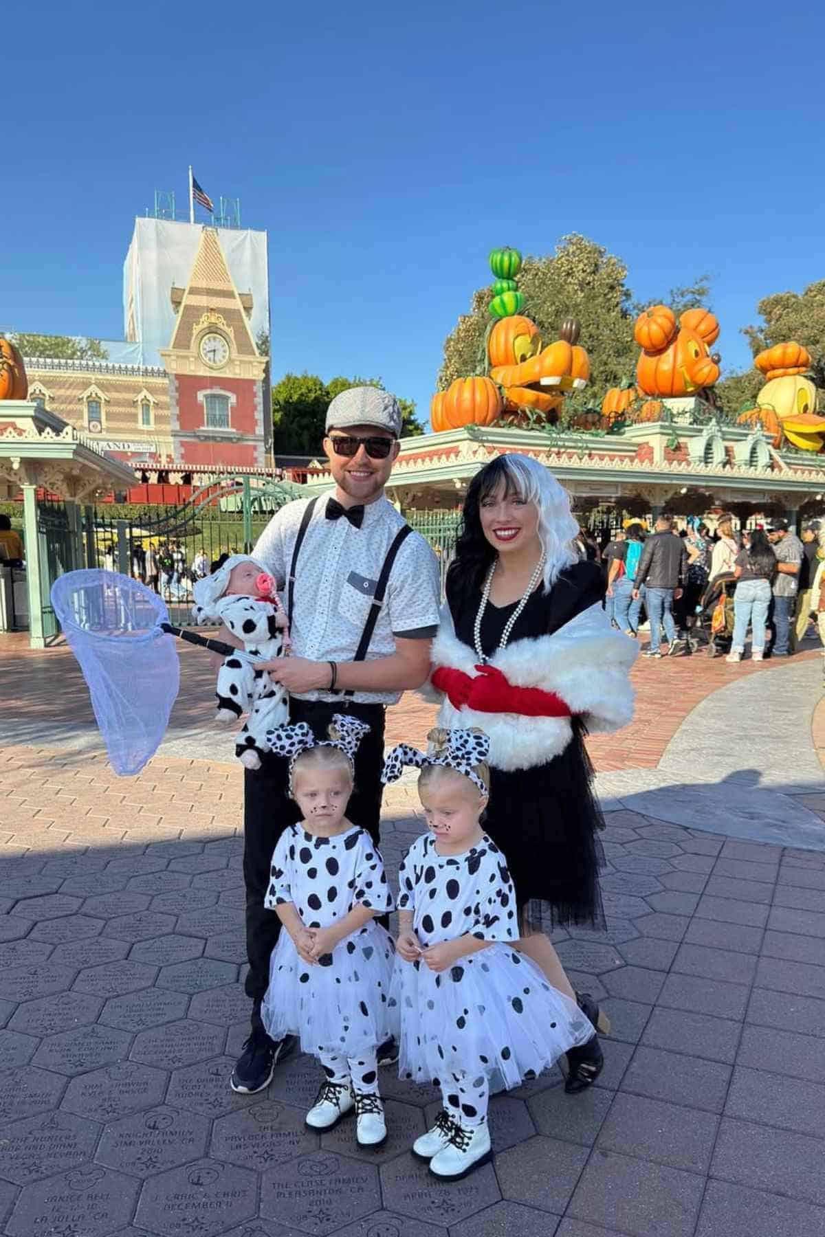 A family of five wearing 101 Dalmatians-inspired costumes.