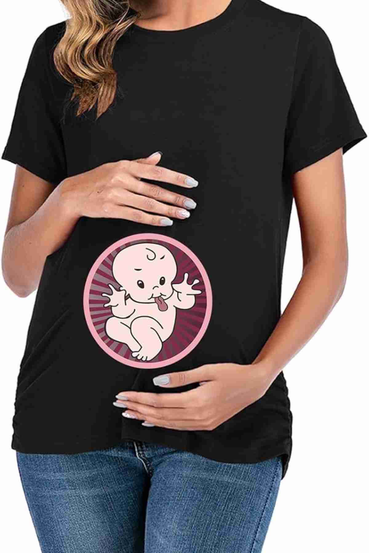 A person wearing a black T-shirt with a cartoon baby graphic on the belly area, holding one hand above and one hand below the graphic.