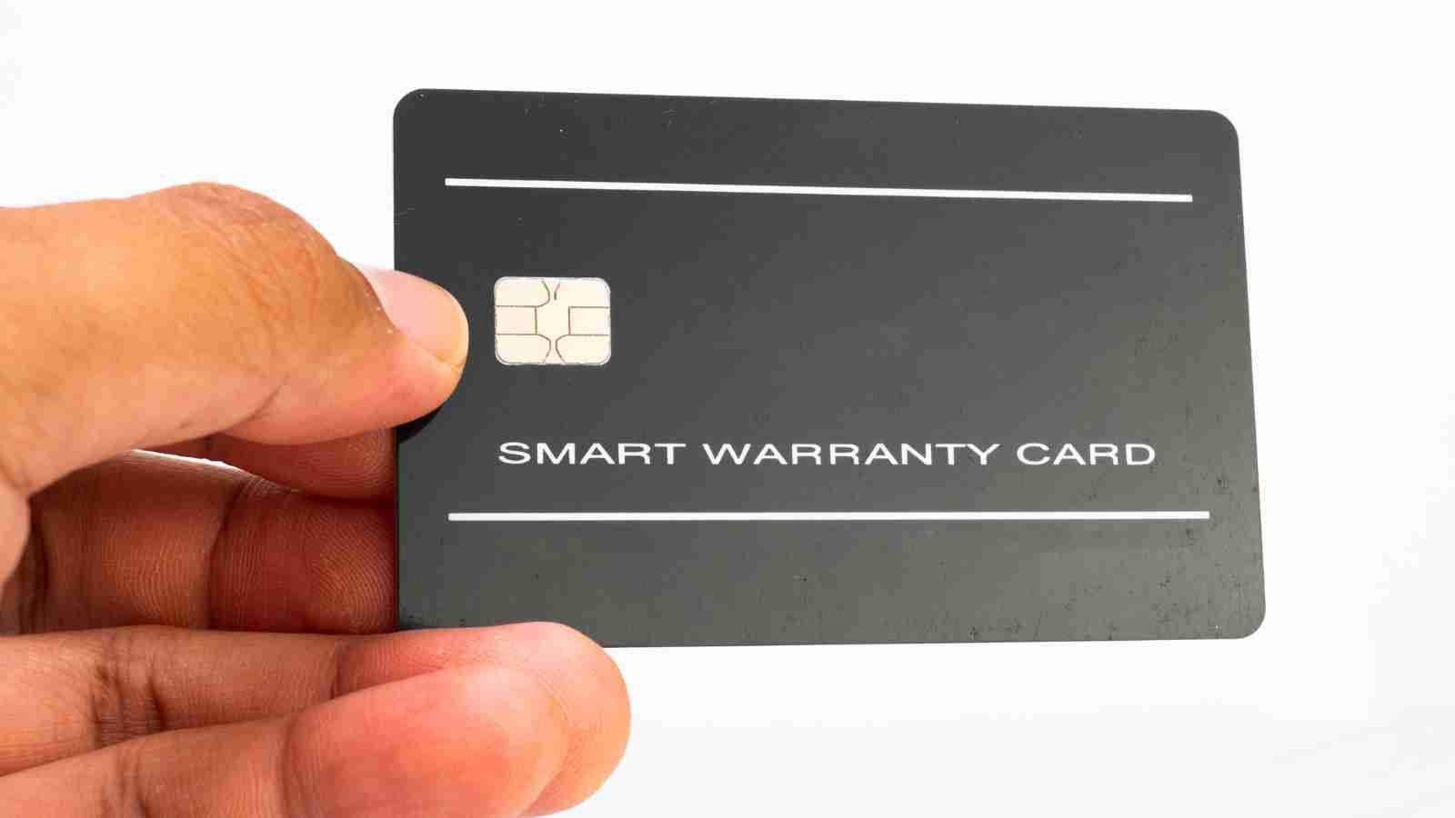 A hand holds up a black smart warranty card with a visible microchip.