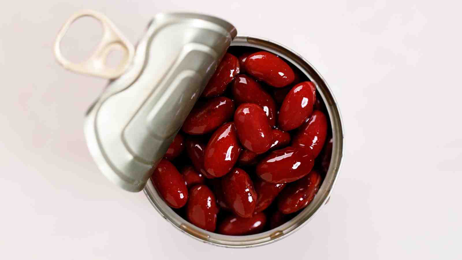 A can of kidney beans is shown open, with the beans visible inside.