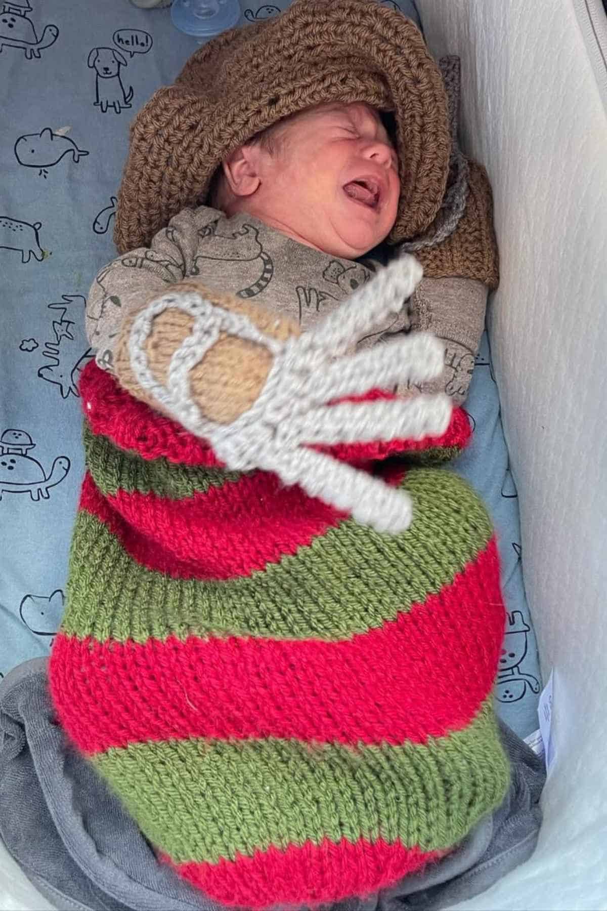 A baby boy dressed as Freddy Krueger.