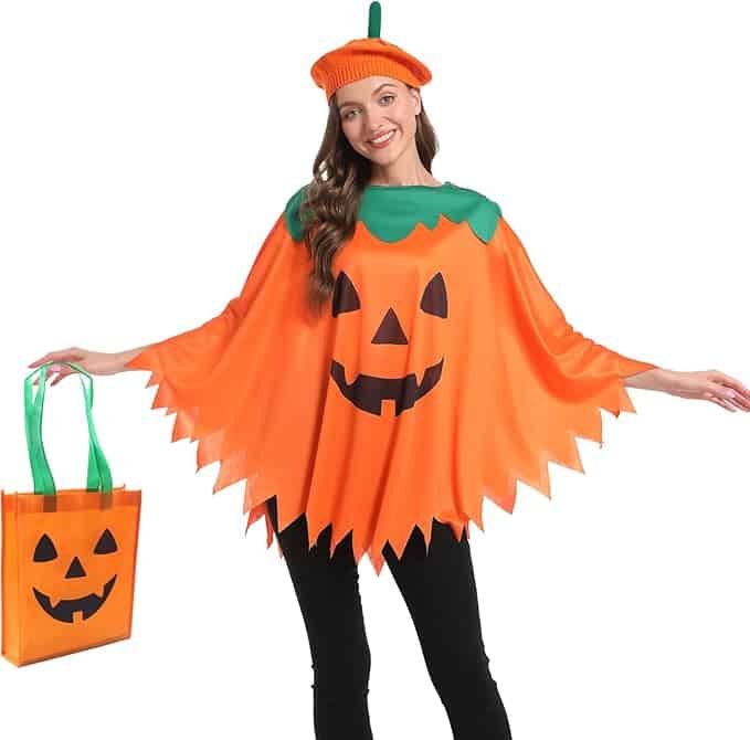 A woman wearing a pumpkin-themed costume and hat stands with arms outstretched, holding a matching pumpkin-face tote bag.