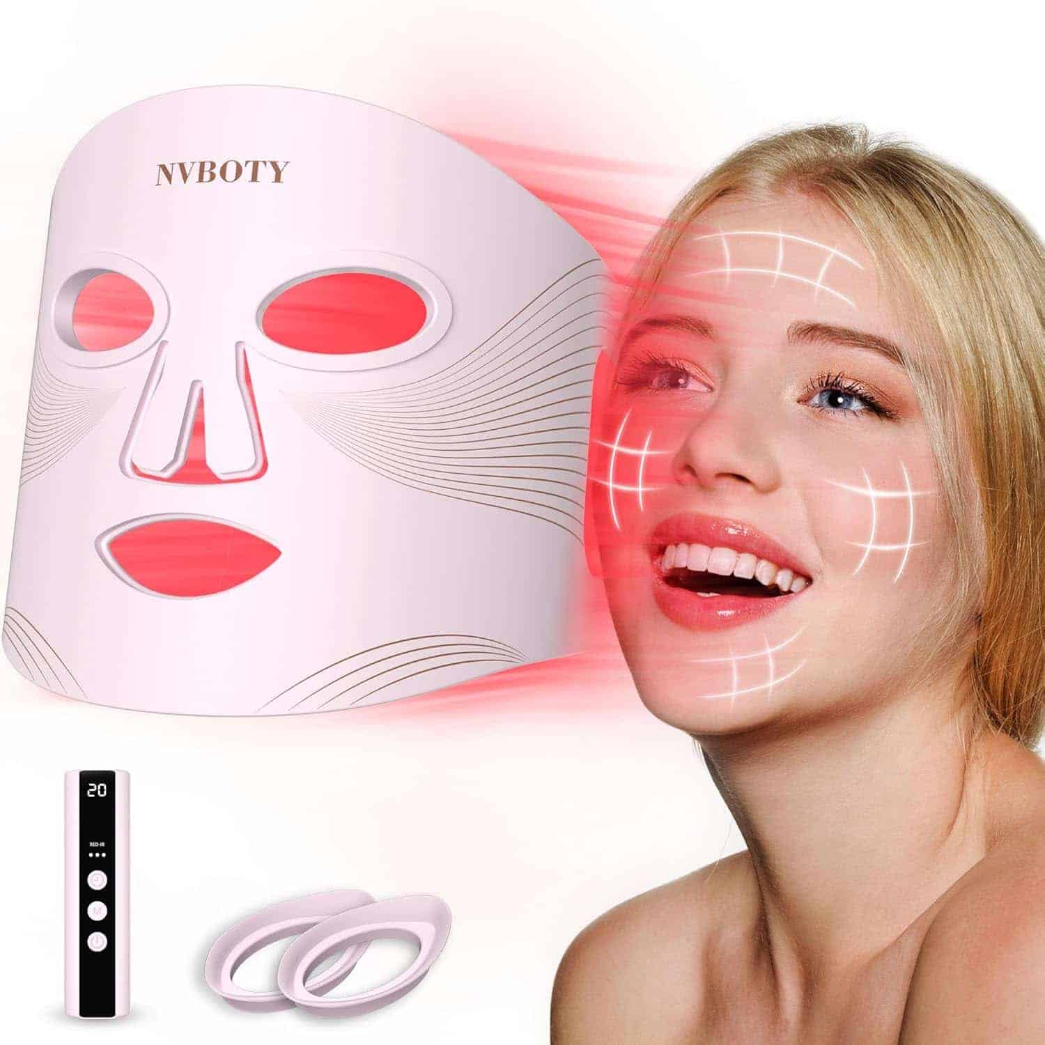 A woman smiles as a LED light therapy facial mask emits red light towards her face; a control device and two silicone rings are displayed nearby.
