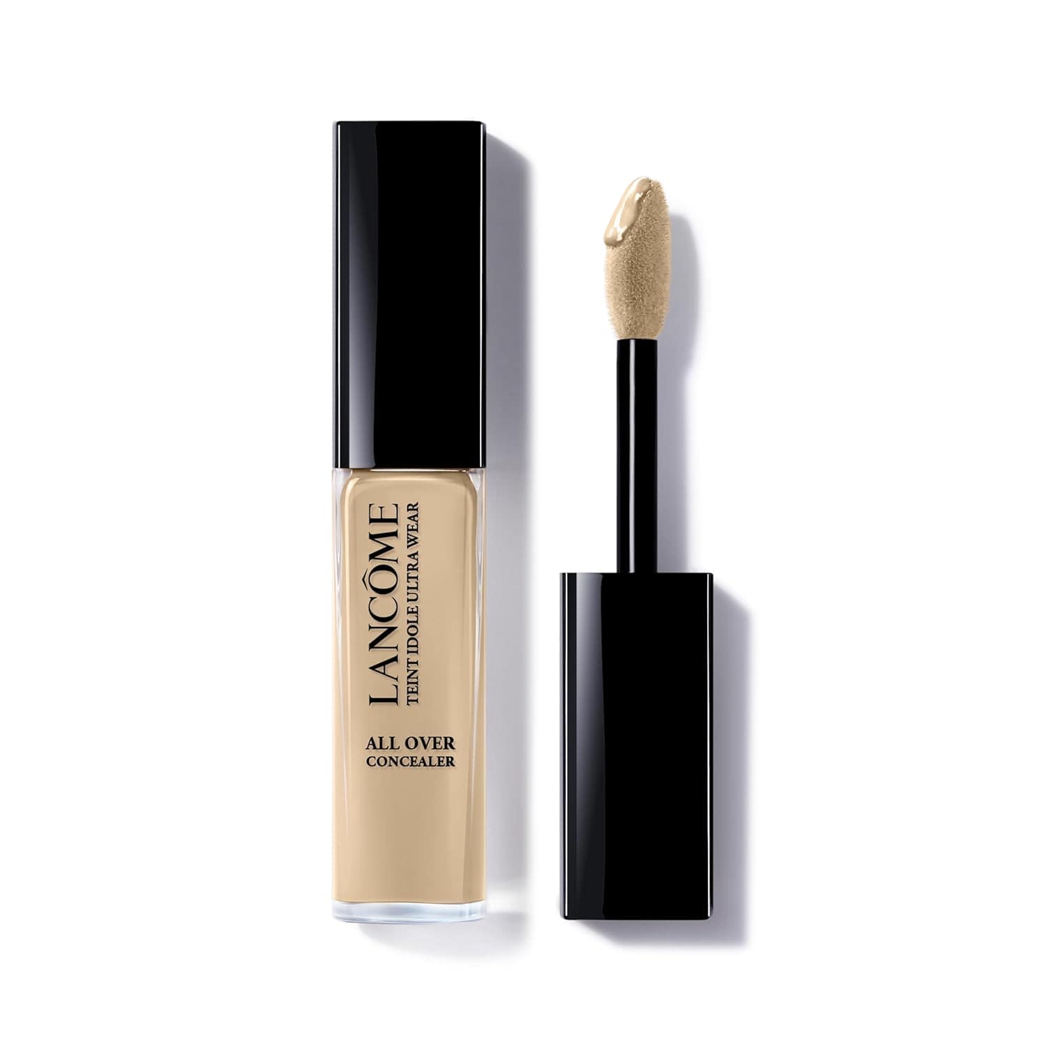 A tube of Lancôme Teint Idole Ultra Wear All Over Concealer with a black cap and attached applicator wand, shown with the wand removed and product visible.