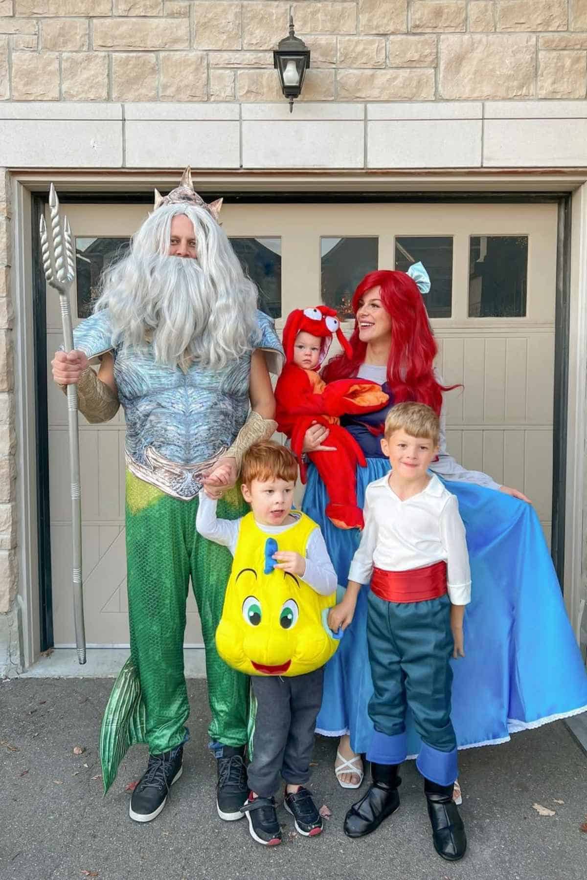 A family of five wearing "The Little Mermaid" costumes.