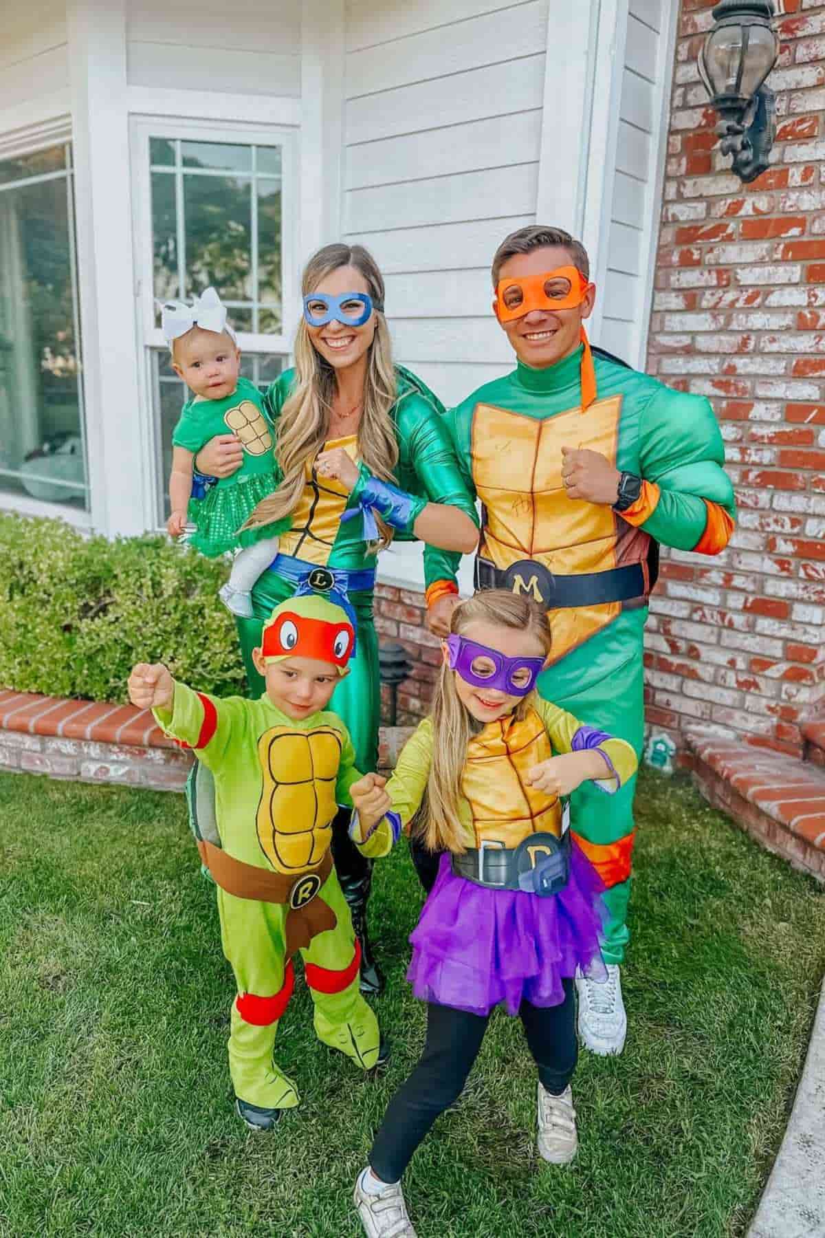 A family of five wearing costumes inspired by Mutant Teenage Ninja Turtles.