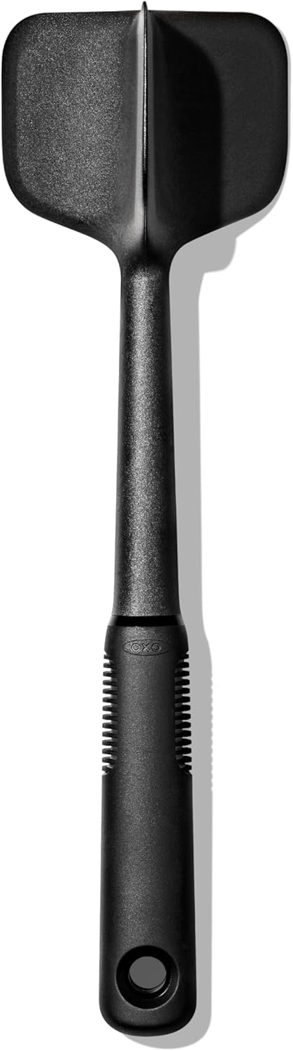 A black nylon spatula with a wide, rectangular head and a grooved handle, shown against a white background.