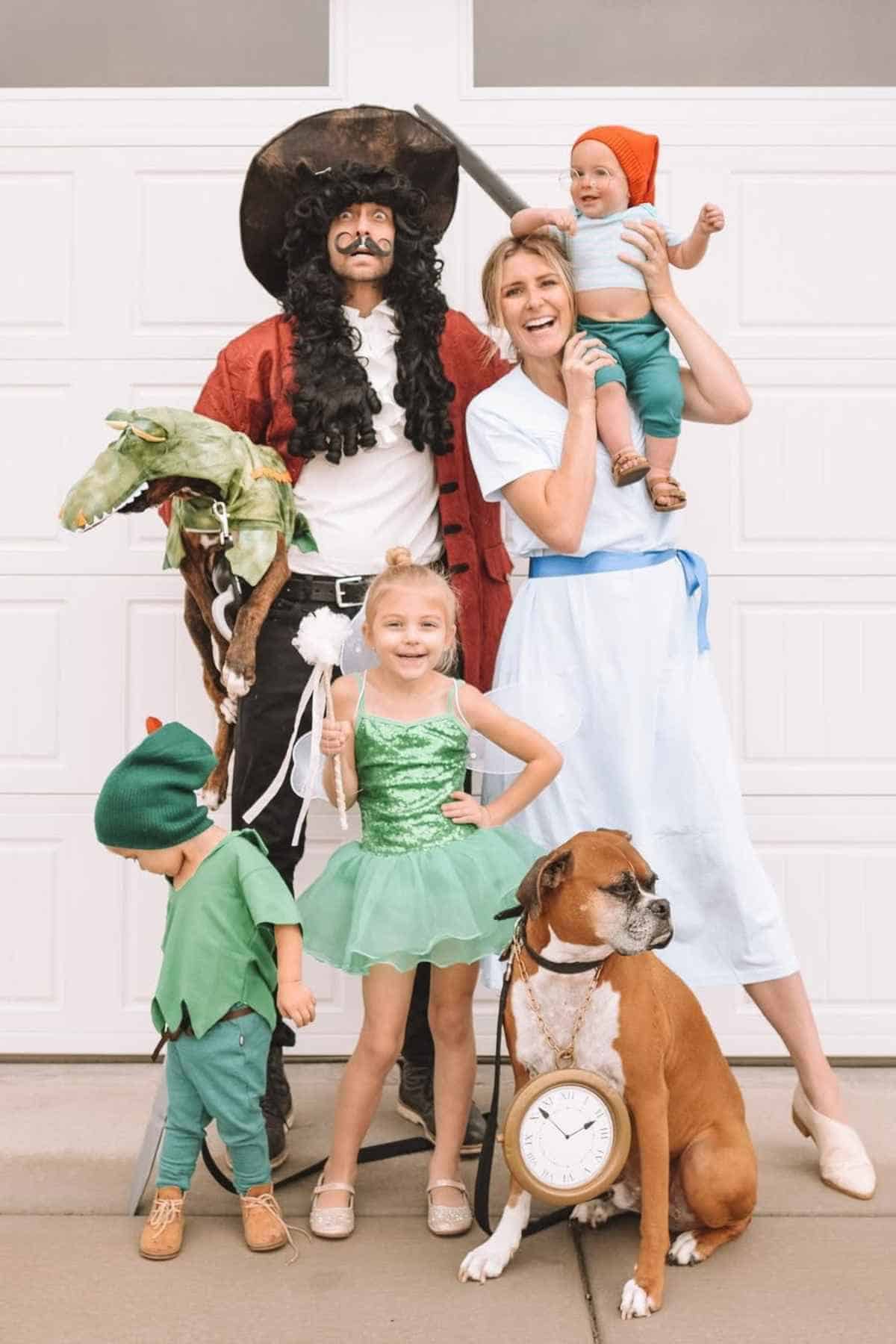 A family of five wearing costumes inspired by the Peter Pan characters.