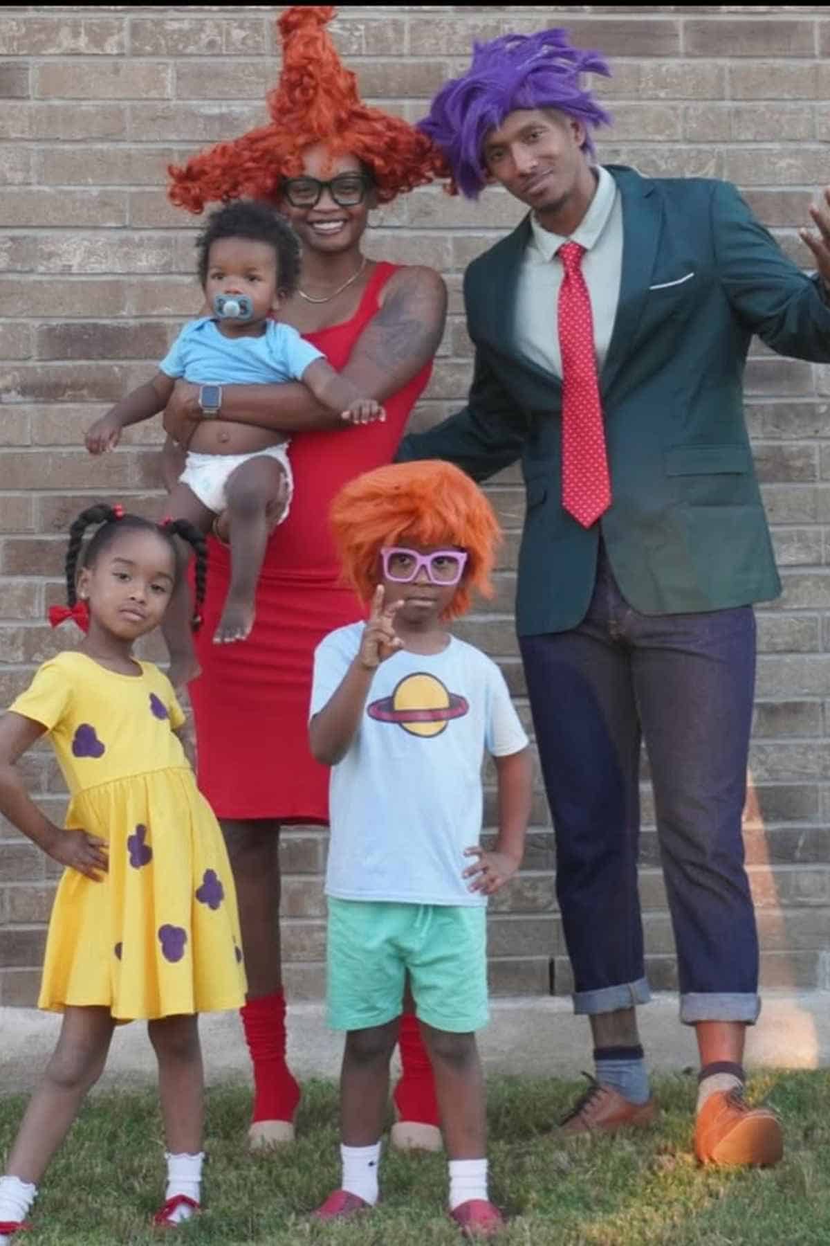 A family of five wearing "Rugrats" costumes.