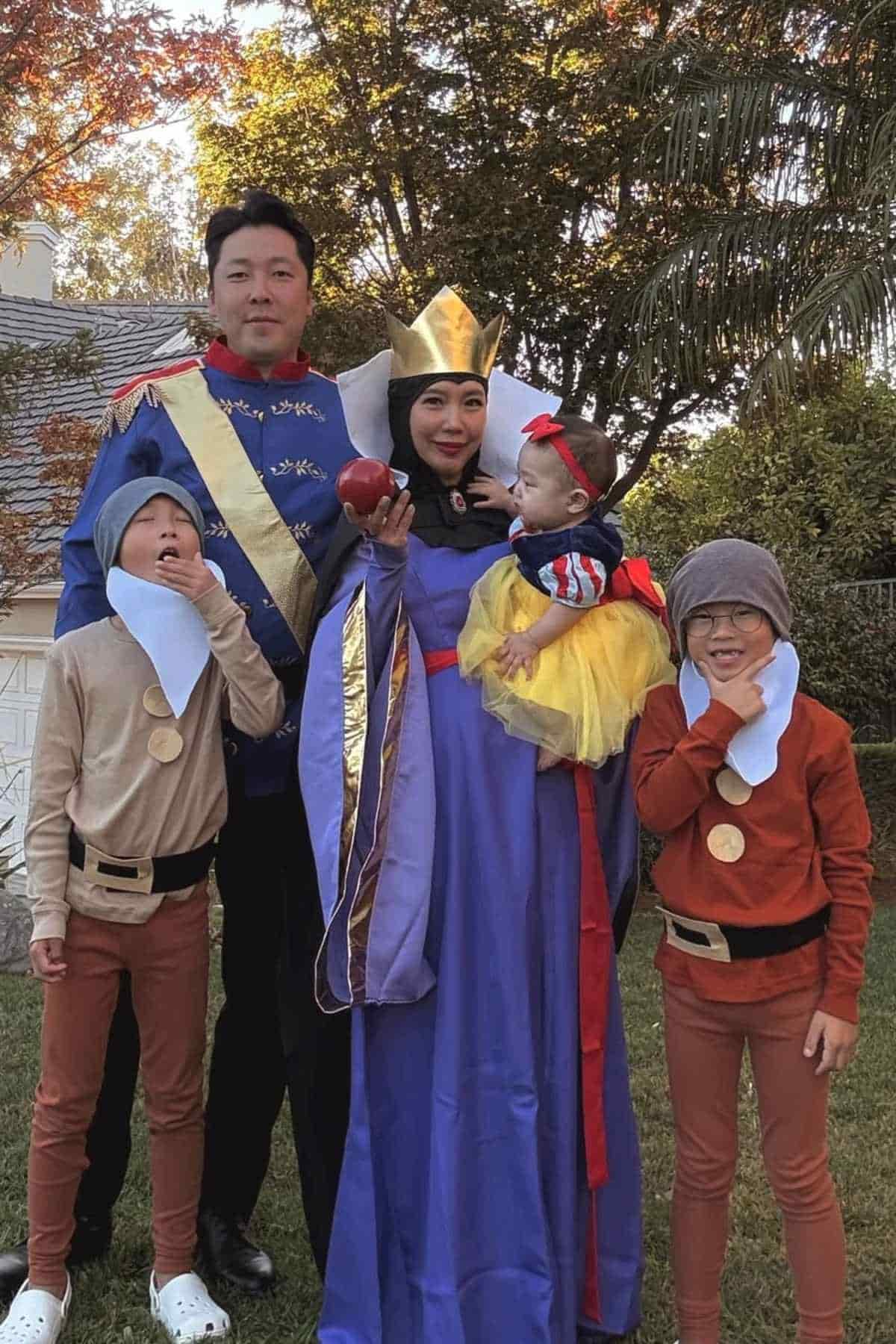 A family of five wearing costumes inspired form the Snow White movie.