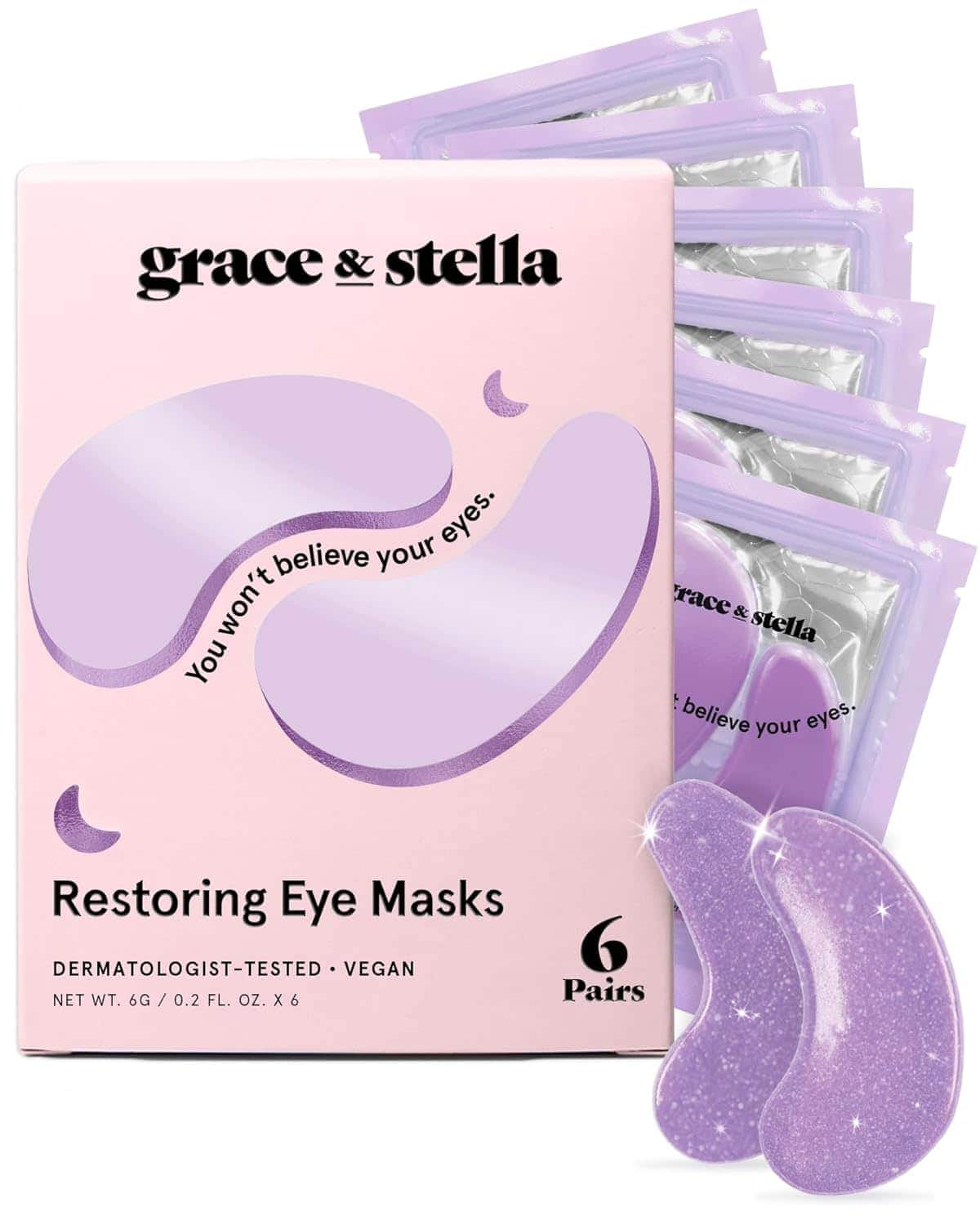 Box of Grace & Stella Restoring Eye Masks with six pairs shown, featuring purple, crescent-shaped gel patches in individual packets.