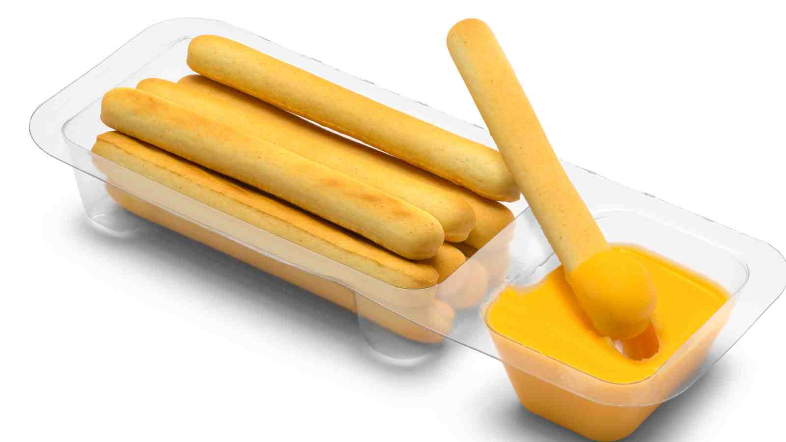 A plastic container holds breadsticks and a small cup of cheese dip, with one breadstick being dipped into the cheese.