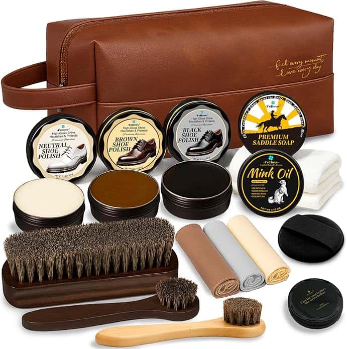 A brown leather shoe care kit containing shoe polishes, saddle soap, mink oil, brushes, cloths, sponges, and a carrying case.