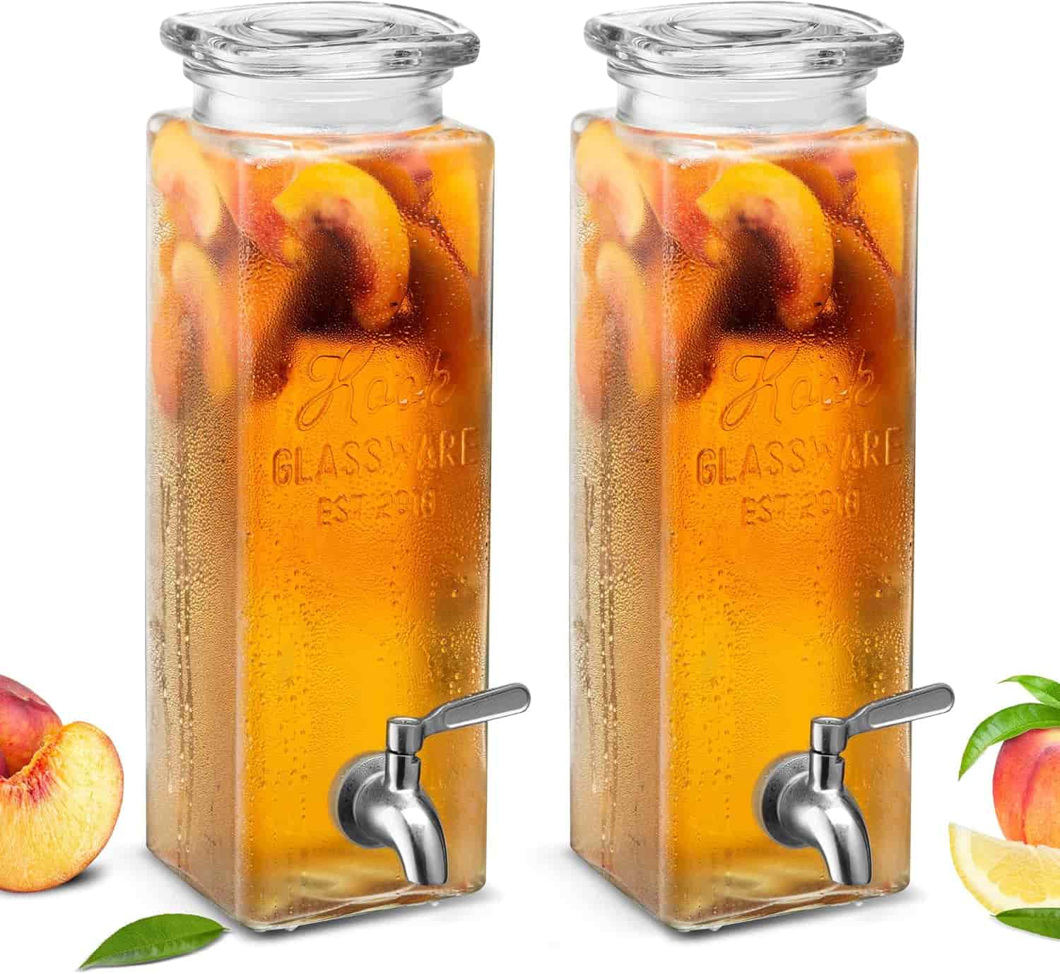 Two rectangular glass beverage dispensers with spigots, filled with iced tea and peach slices, are shown side by side against a white background.