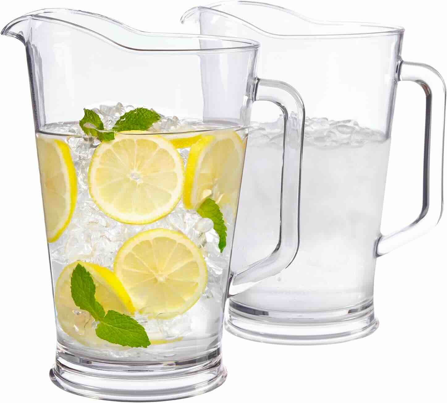 Two clear glass pitchers; one filled with ice, lemon slices, mint leaves, and water, the other containing ice and water only.