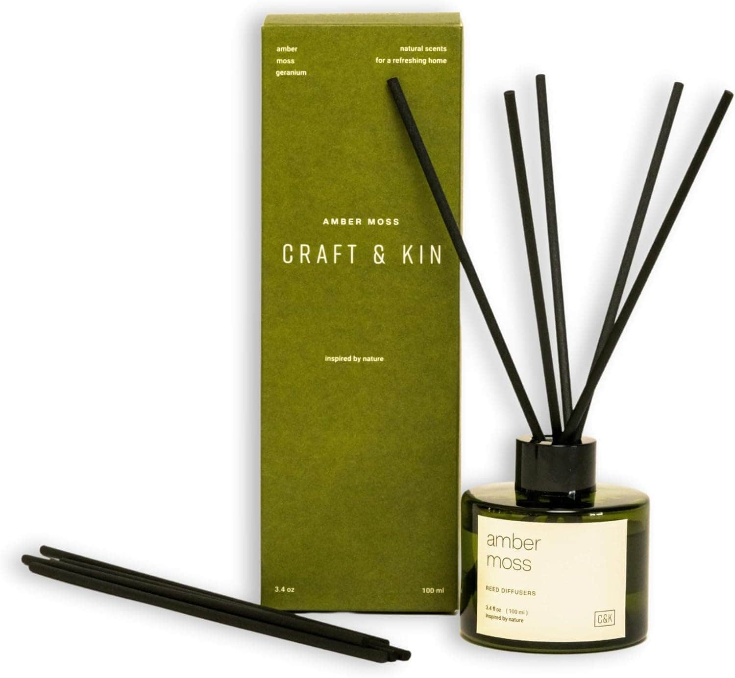 A green box with black sticks in a bottle.