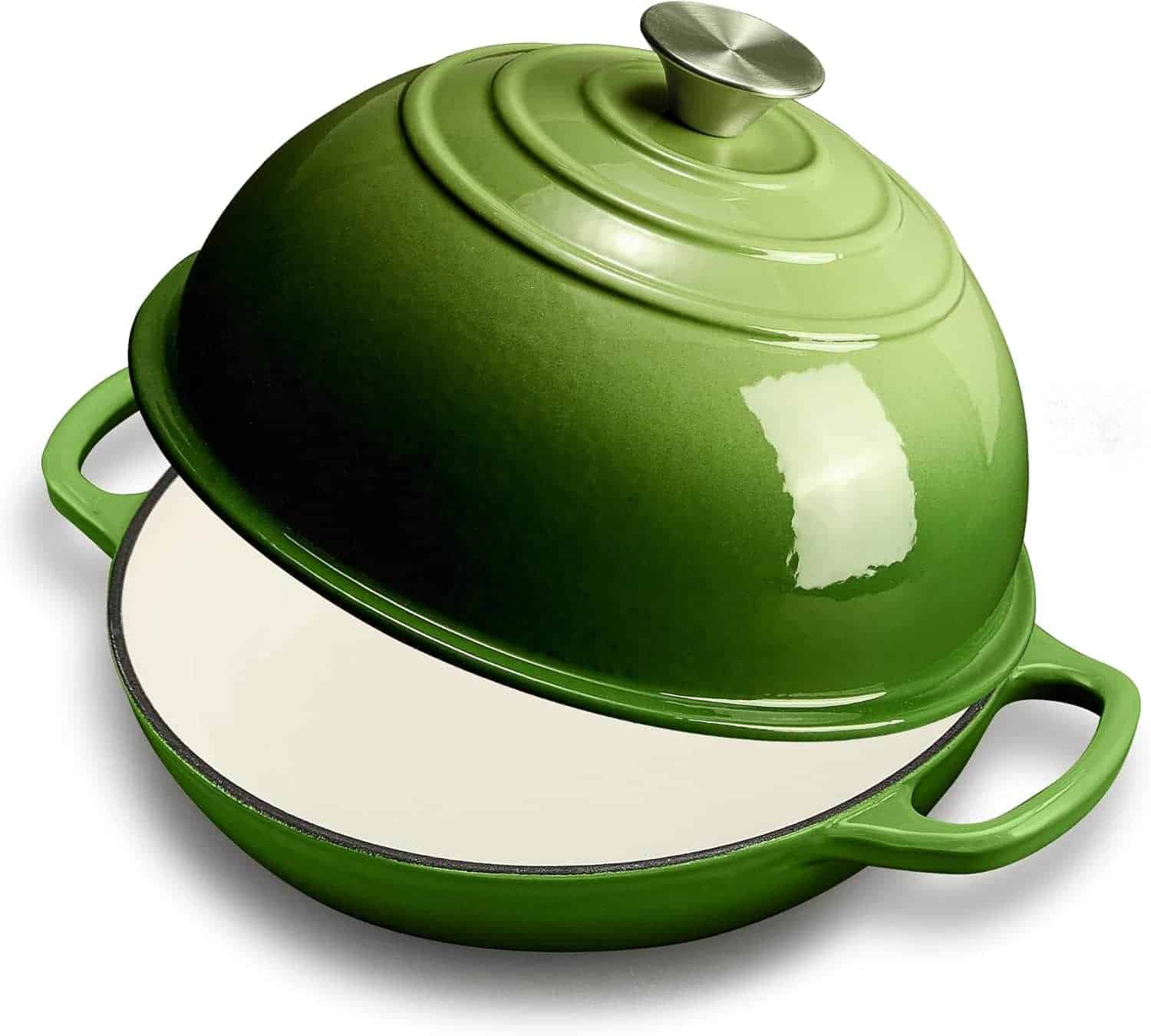 A green enameled cast iron Dutch oven with a dome-shaped lid, partially open to show the white interior and two side handles.