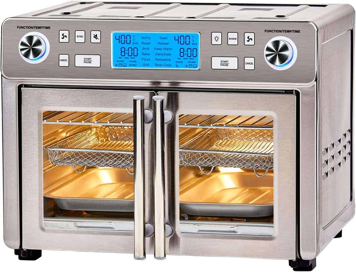 A stainless steel countertop air fryer oven with double glass doors, digital display, control knobs, and multiple cooking racks inside.