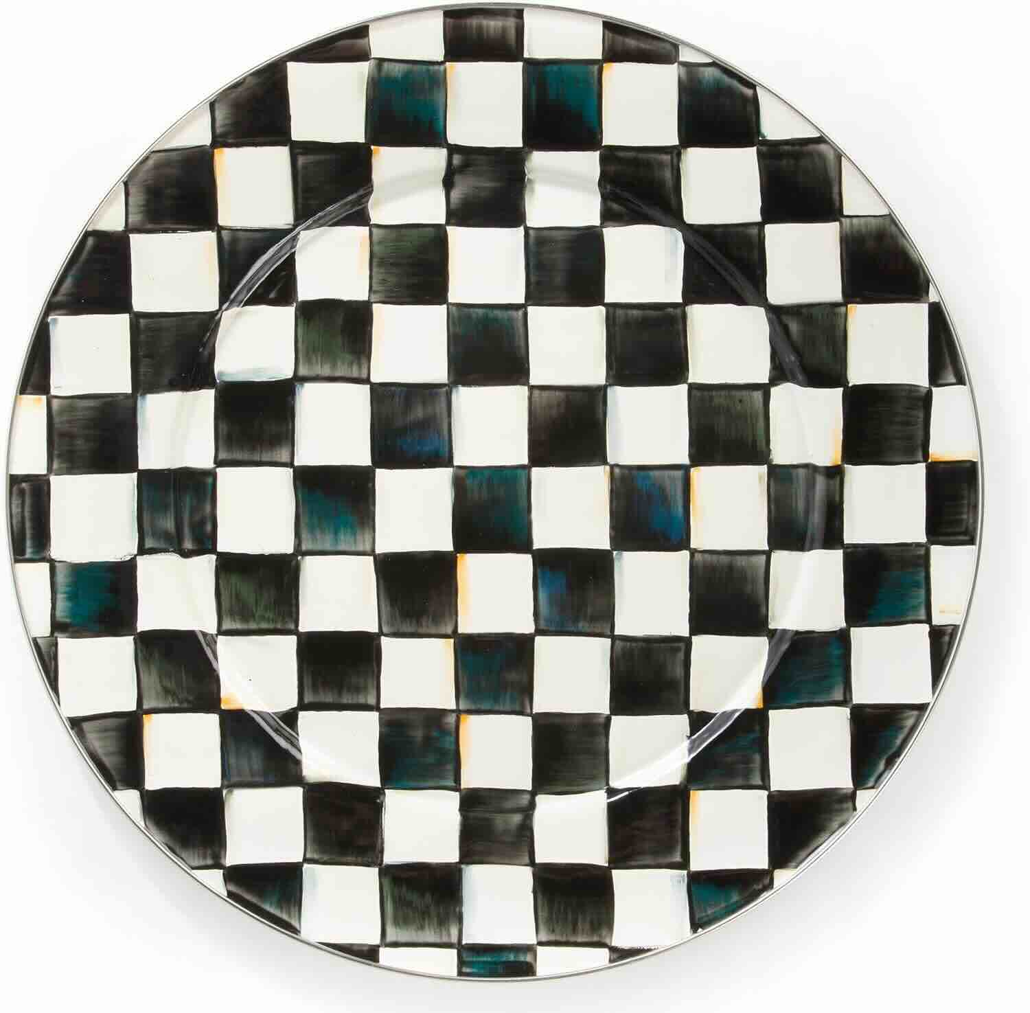 A round ceramic plate featuring a black and white checkerboard pattern.