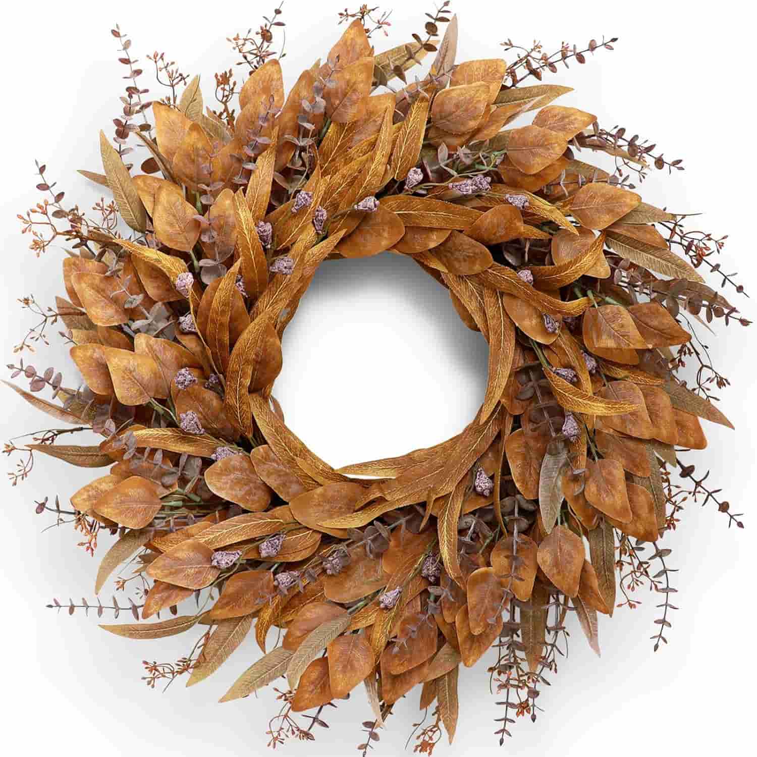 A circular wreath made of dried brown leaves and small purple accents arranged in a dense, layered design.