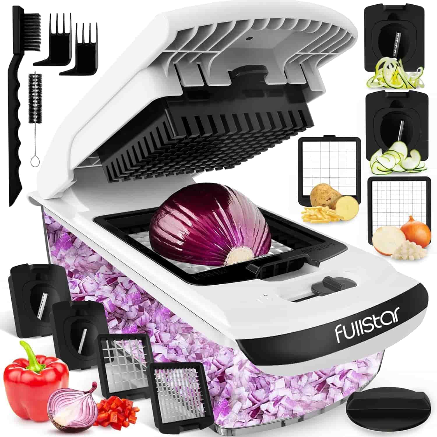 A vegetable chopper with a diced red onion inside, multiple interchangeable blades, a cleaning brush, and various chopped vegetables displayed around it.