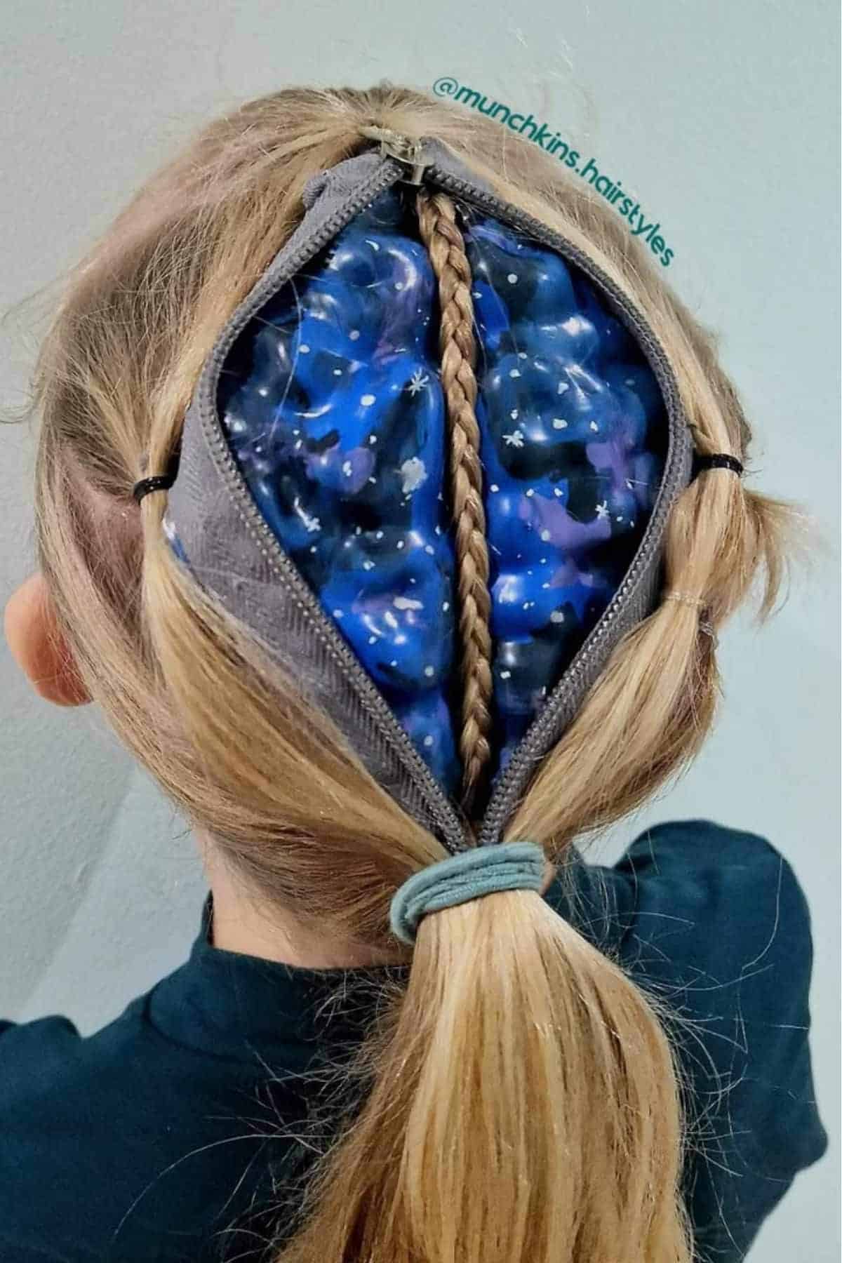A hairstyle designed to look like a zipper unzipping the hair, revealing a blue and purple galaxy pattern beneath.