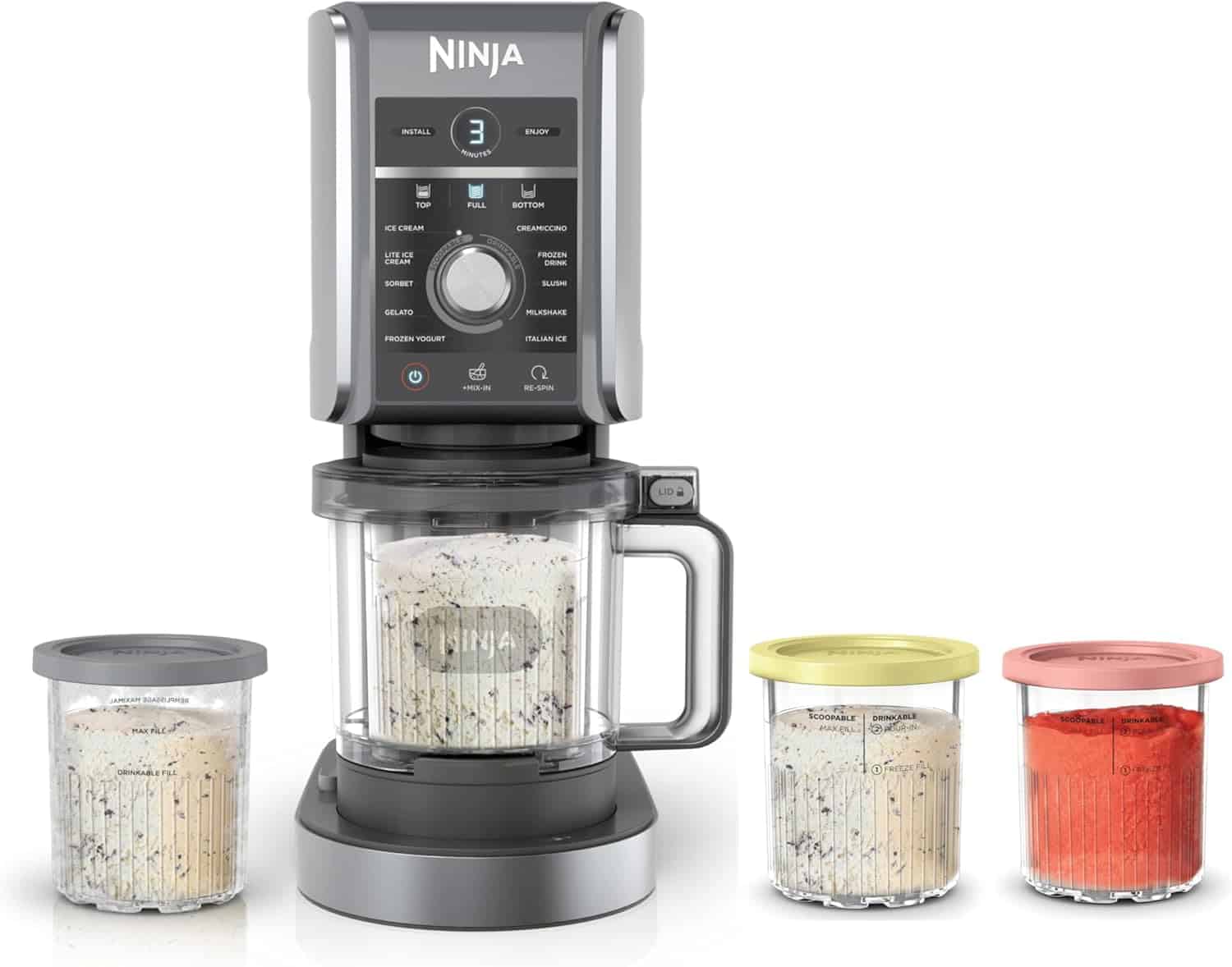A Ninja food processor with a main blending unit and three additional storage containers filled with various chopped or ground ingredients.
