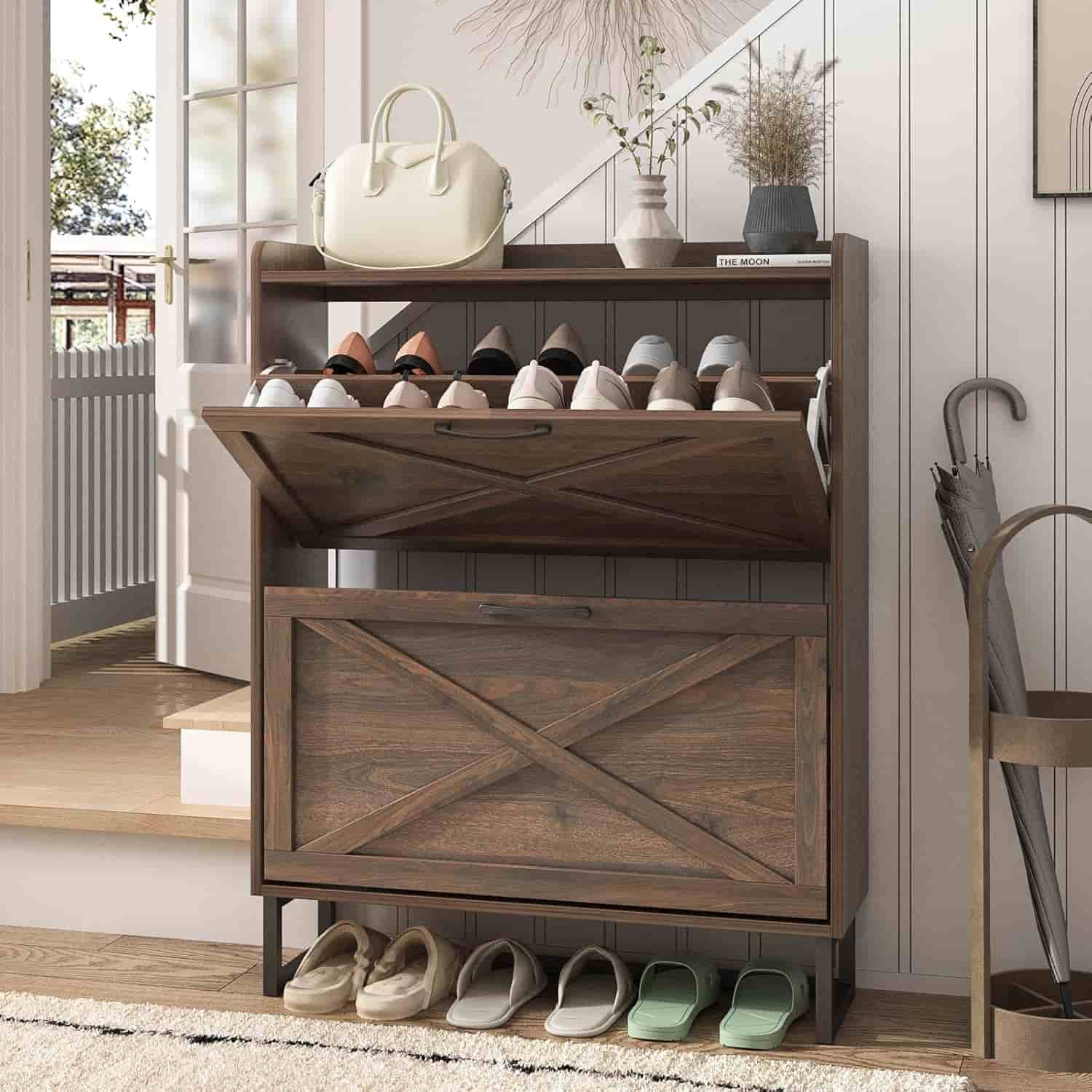 A wooden shoe storage cabinet with open and closed compartments holds various pairs of shoes, with a handbag and decorative items placed on top.
