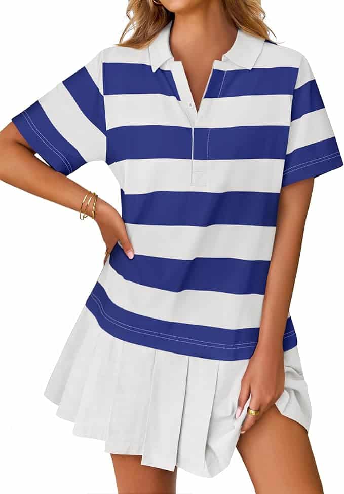 A woman wears a short-sleeved dress with wide blue and white horizontal stripes on the top and a white pleated skirt at the bottom.