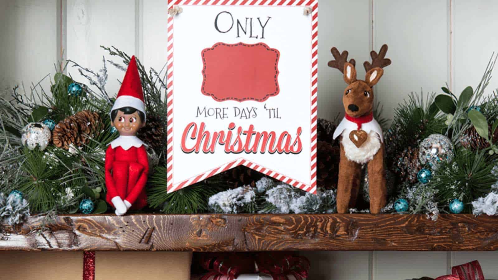 A festive shelf decorated with an elf doll, a reindeer figure, greenery, pinecones, and a sign that says "Only ___ More Days 'Til Christmas.