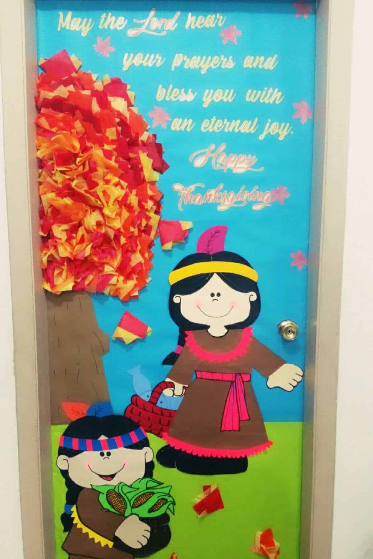 A door decorated with cartoon children in Native American attire, a tree with red and orange leaves, and Thanksgiving greetings in white and yellow text.