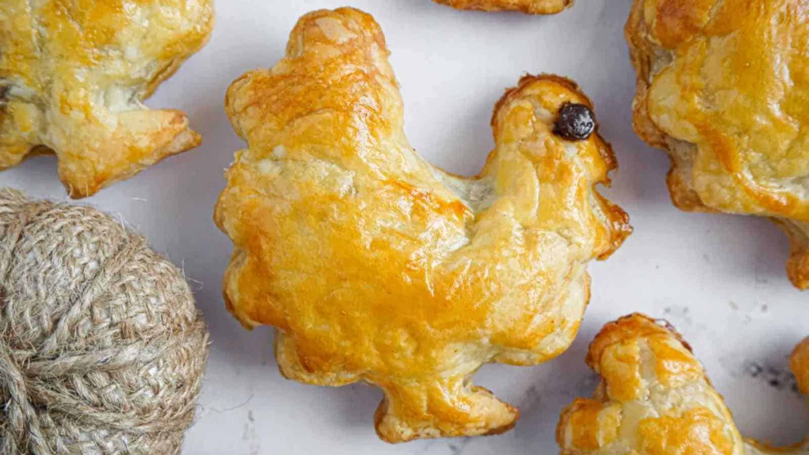 A golden-brown, turkey-shaped pastry sits on a white surface, with a piece of brown twine nearby.