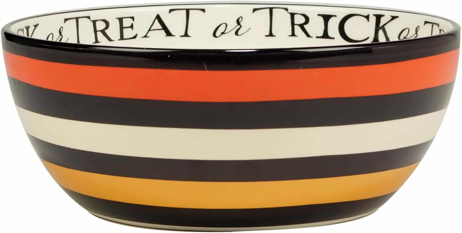 A ceramic bowl with orange, black, white, and yellow horizontal stripes and "Trick or Treat" written around the inner rim.