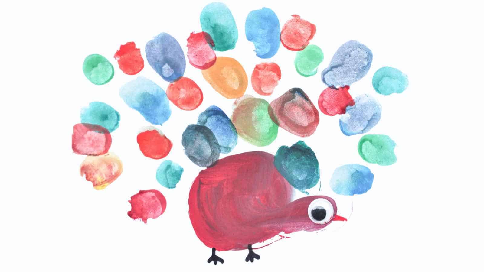 A colorful peacock made with painted fingerprints for feathers and a red painted body, set against a white background.