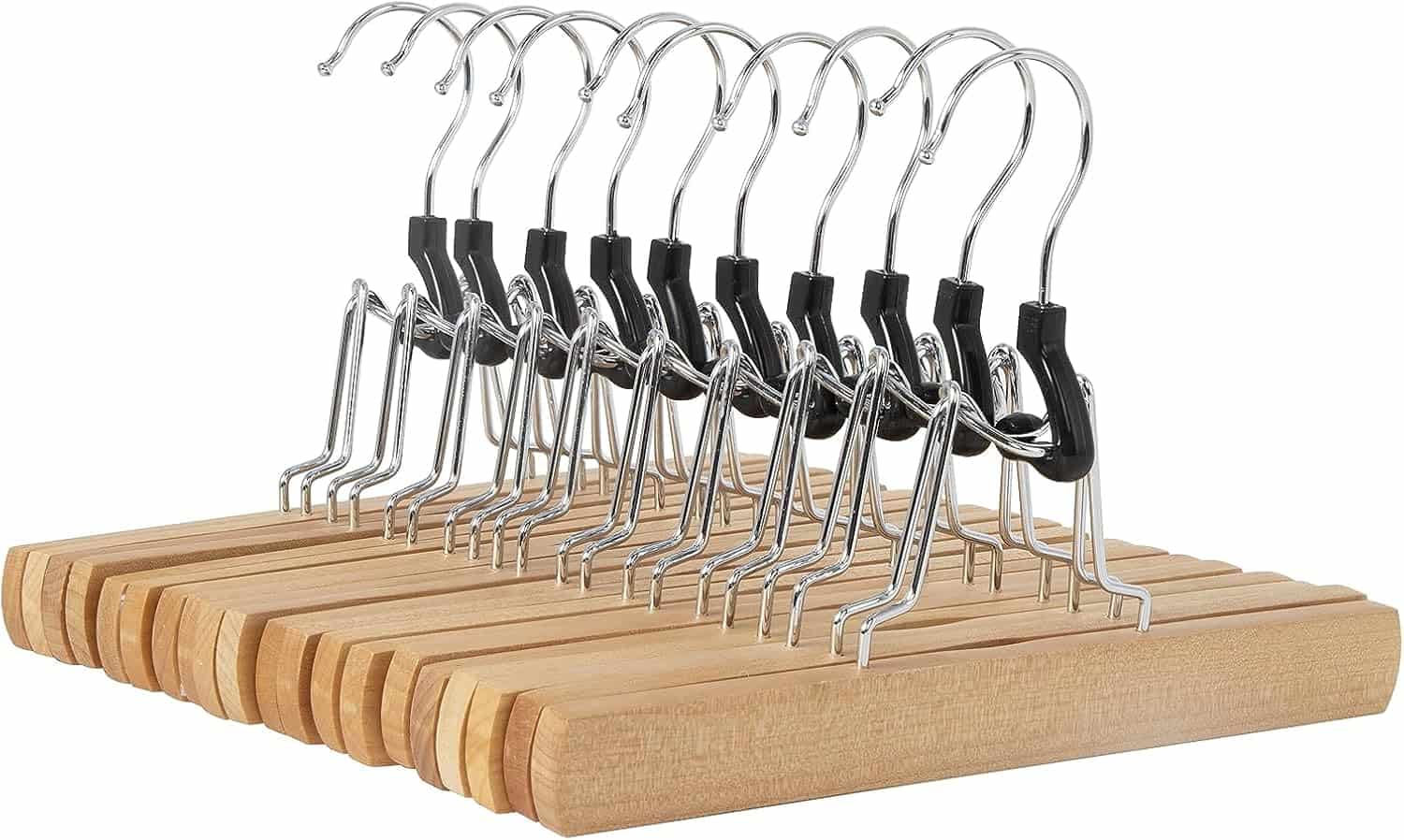 A row of wooden clothes hangers with metal hooks and black clips, arranged neatly against a white background.