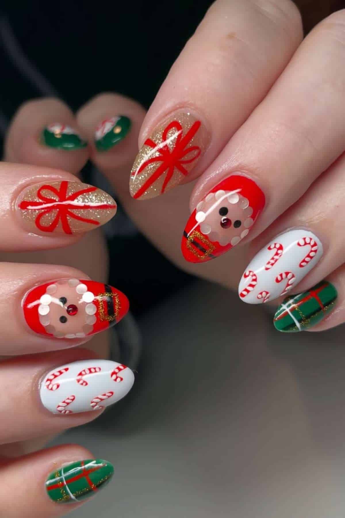 Fingernails painted with Christmas-themed designs, including Santa faces, candy canes, gift wrap patterns, and red bows on a mix of red, green, and white base colors.