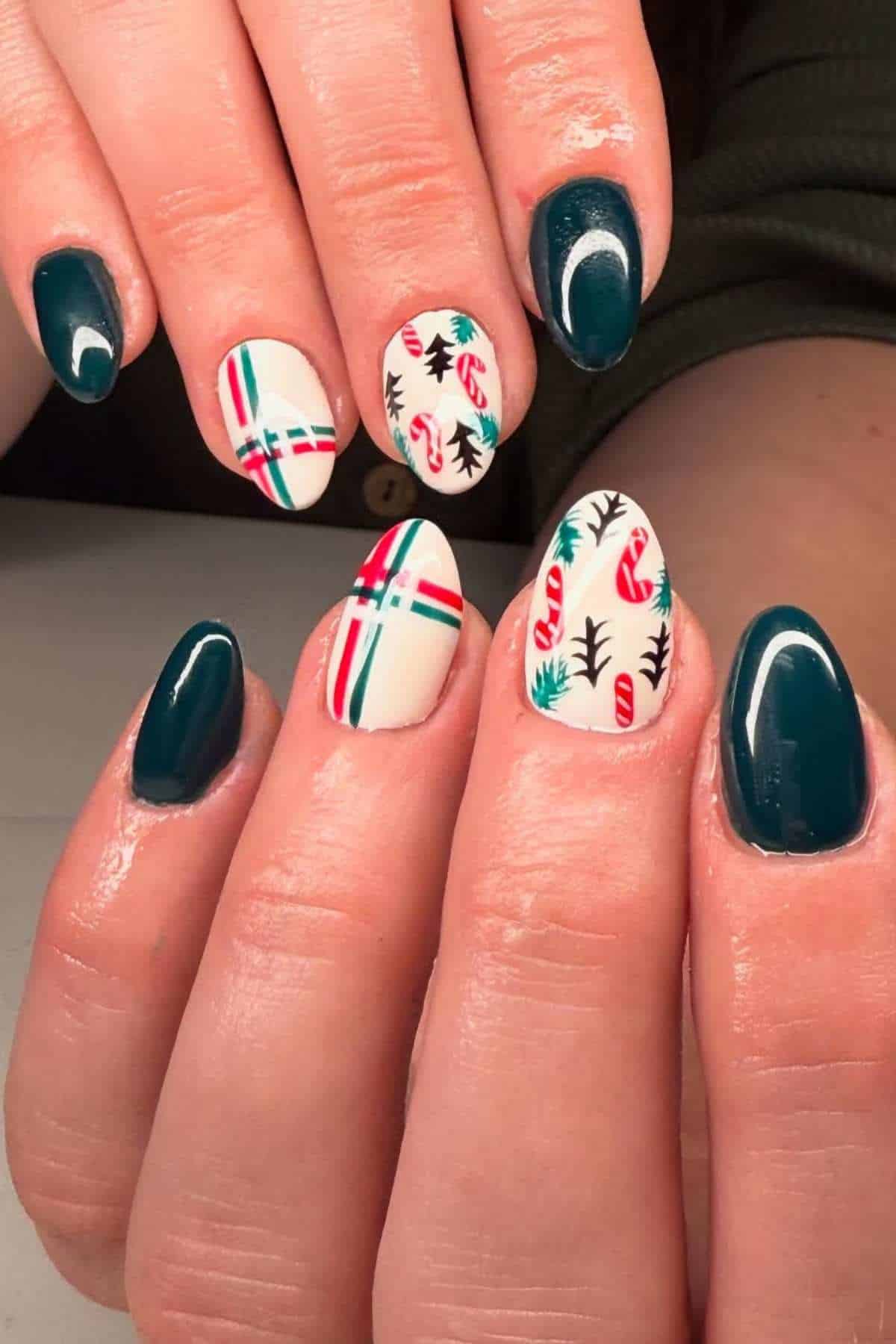 Hands with teal-colored nails and accent nails decorated with white backgrounds, red and green plaid lines, and festive candy cane and leaf designs.