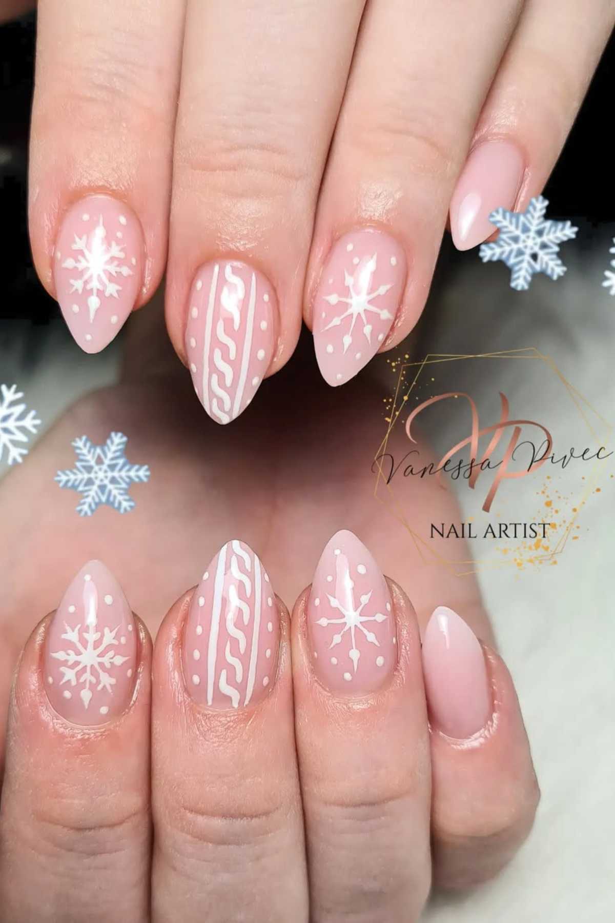 Hands with almond-shaped nails featuring pink polish and white winter designs, including snowflakes and sweater patterns.