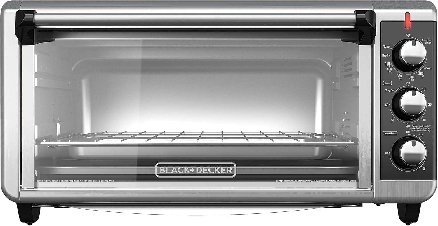 A stainless steel BLACK+DECKER toaster oven with a glass door, three control knobs, and a wire rack inside.