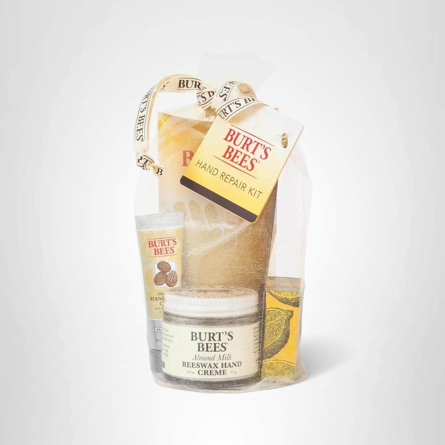 A Burt's Bees Hand Repair Kit in a sheer drawstring bag, containing lotion, hand cream, cuticle cream, and gloves, with a product tag attached.