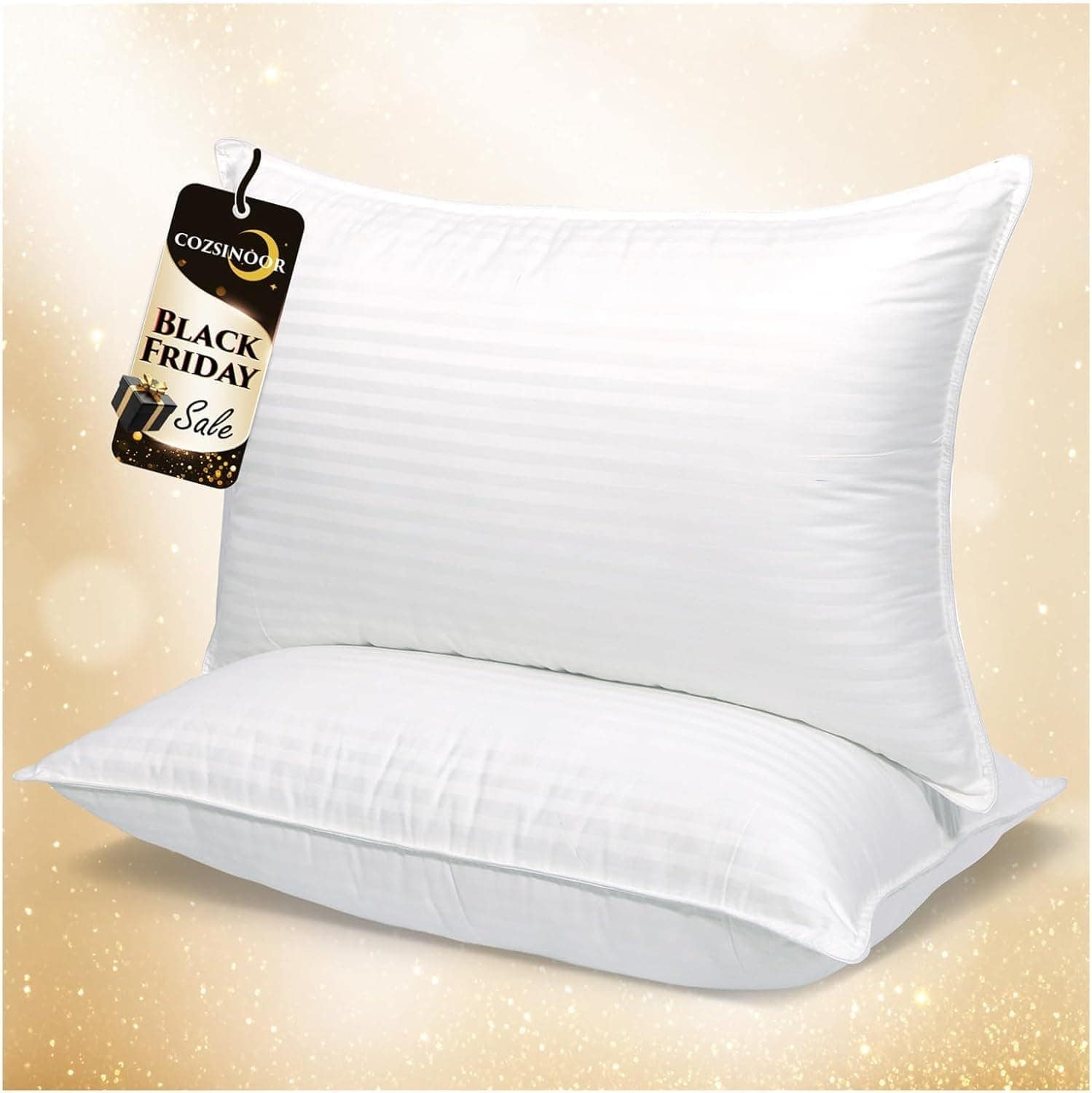 Two white pillows stacked against a gold, sparkly background with a "Black Friday Sale" tag attached to the top pillow.